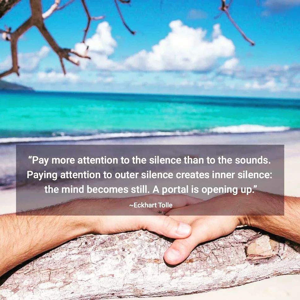 A photo realistic person’s hands resting on a wooden railing overlooking a beautiful beach. The image is meant to convey a sense of peace and tranquility. The image also has a quote on it that reads “Pay more attention to the silence than to the sounds. Paying attention to outer silence creates inner silence: the mind becomes still. A portal is opening up.” -Eckhart Tolle.